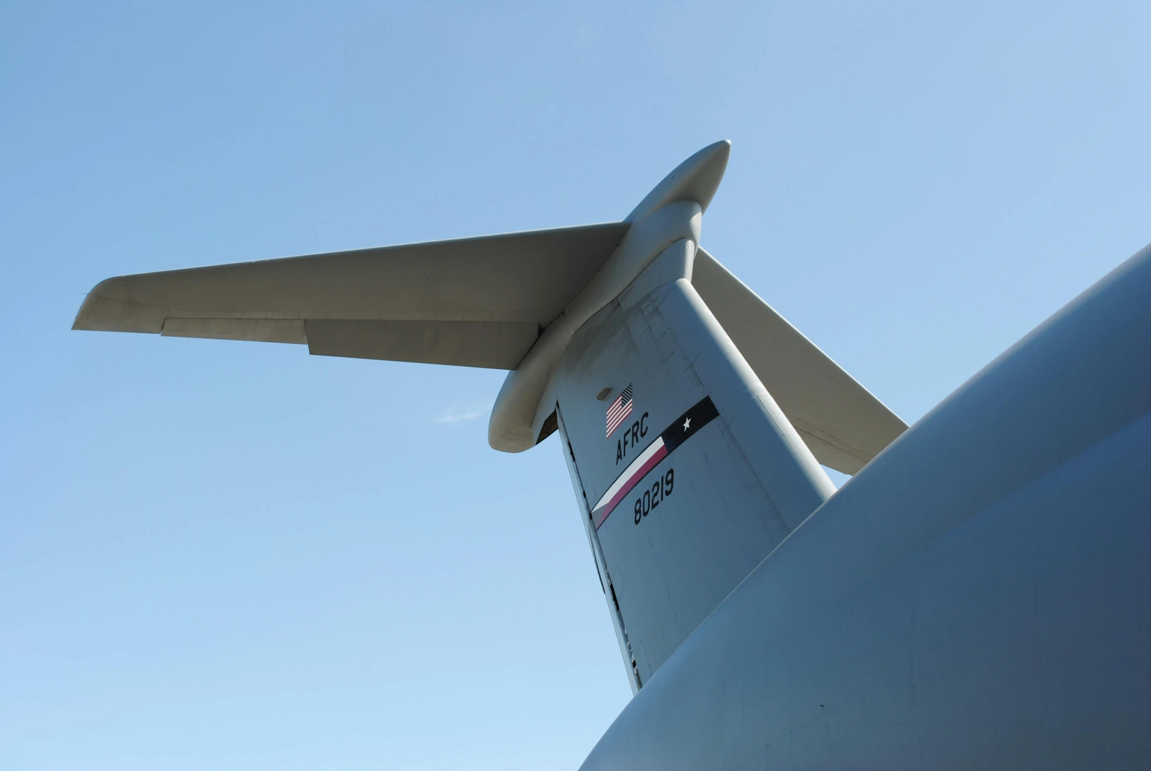 the tail of a plane with its landing gear deployed