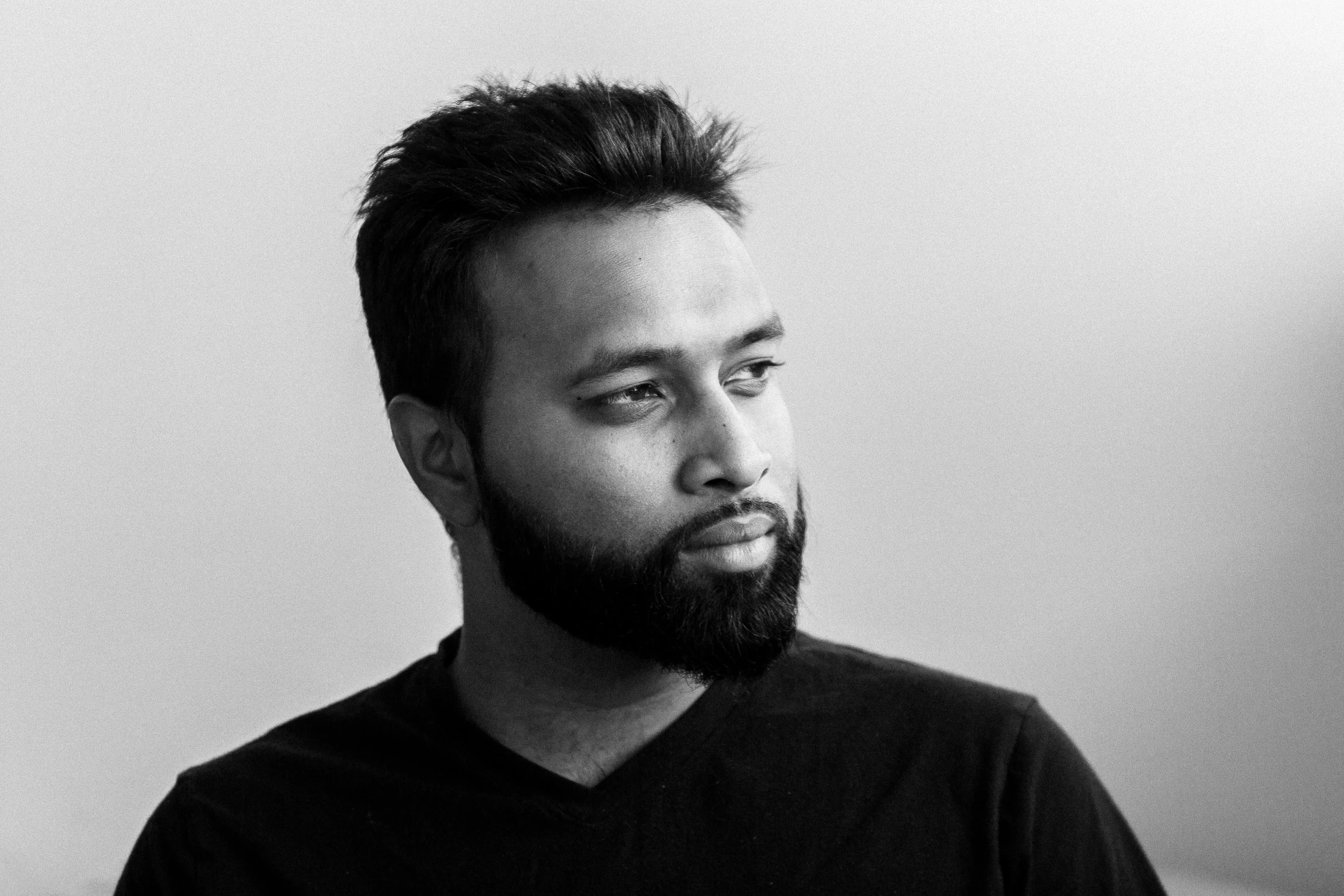 black and white pograph of man in plain black shirt