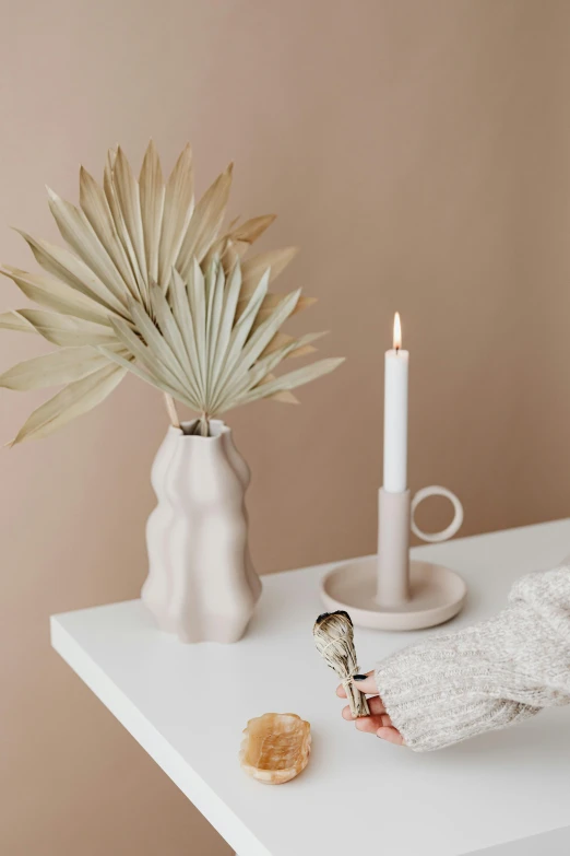 there are two small candles sitting on a white table