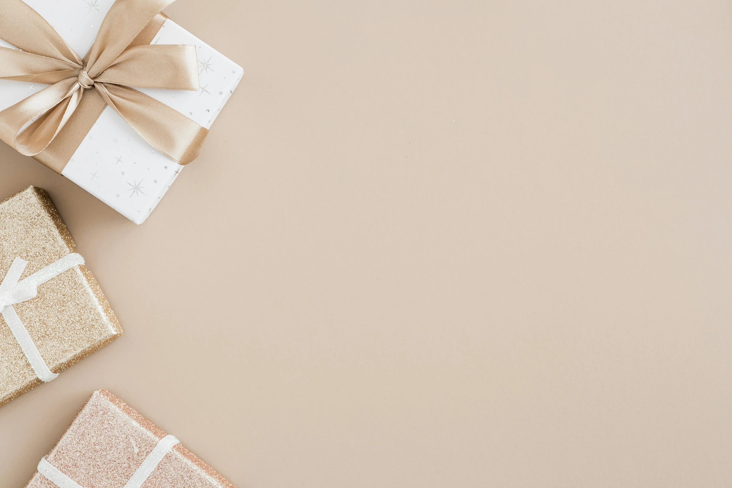 two white and gold wrapping paper wrapped presentes