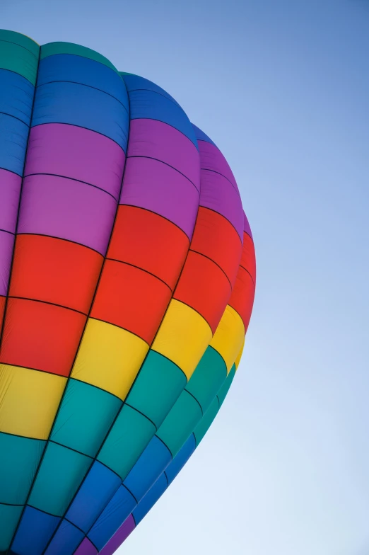 a colorful  air balloon flying in a clear blue sky