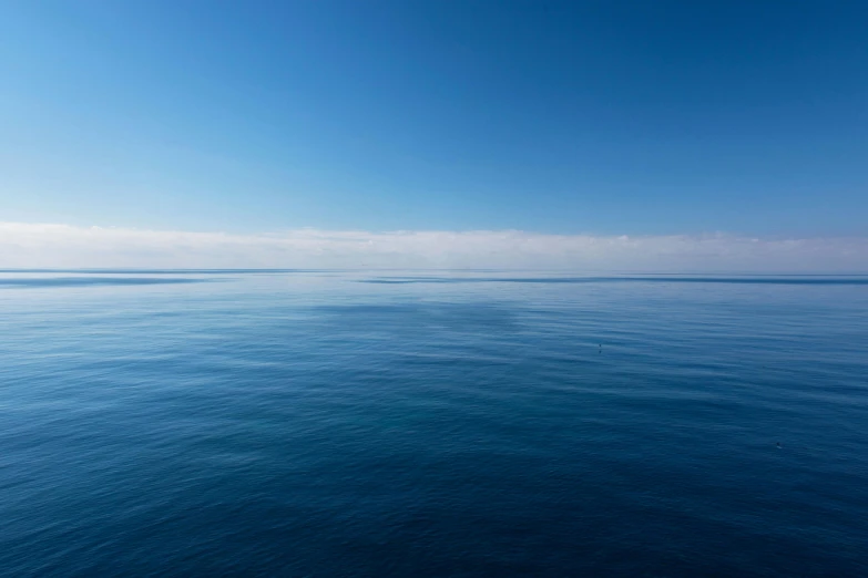 a large body of water that has a small boat out in it