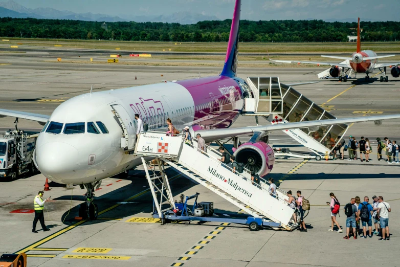 a group of people getting off of an airplane