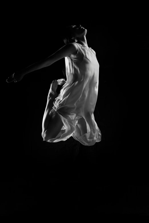 black and white po of a woman jumping high in the air