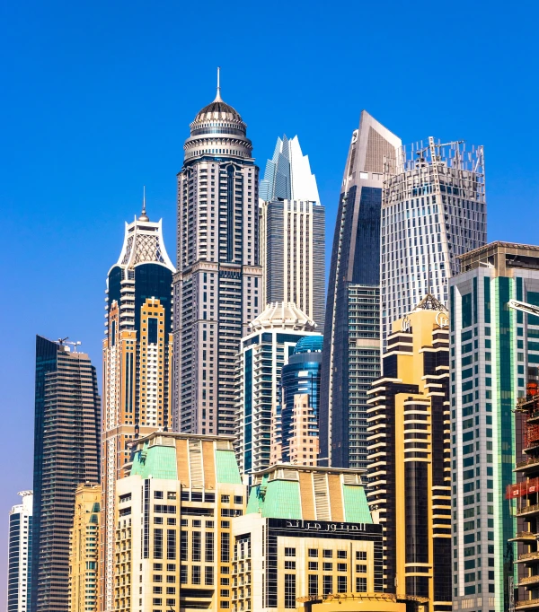 a view of some very tall buildings on the water