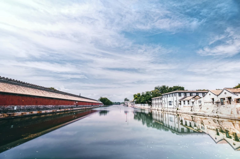 a canal is surrounded by buildings and trees