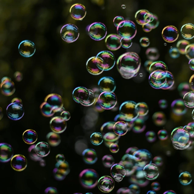 a bunch of bubbles that are hanging from a string