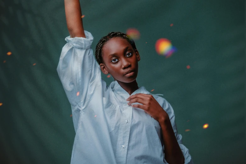 an african woman posing with her arms up and looking at the camera