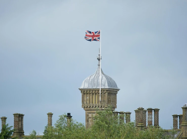 a tall tower with a british flag on top