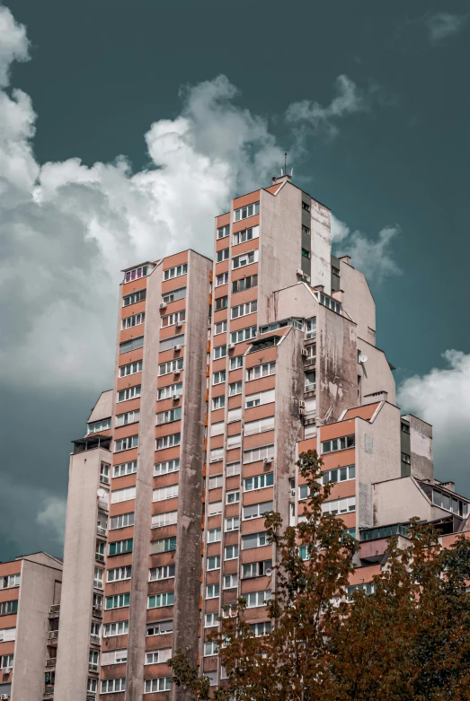 a tall building with many windows and balconies