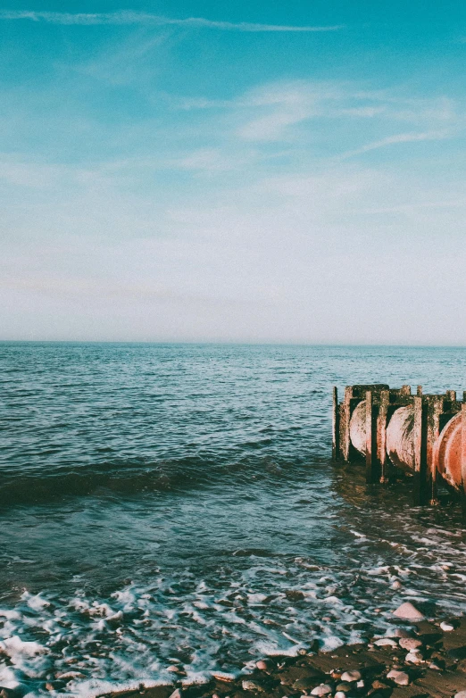 the view from the beach shows water around a pier