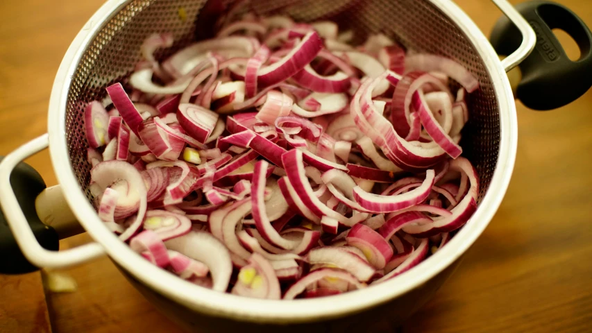 onions cut in half are being prepared and cooked