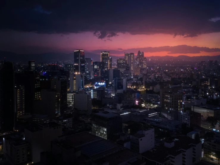 a city is shown during the night with a large amount of clouds