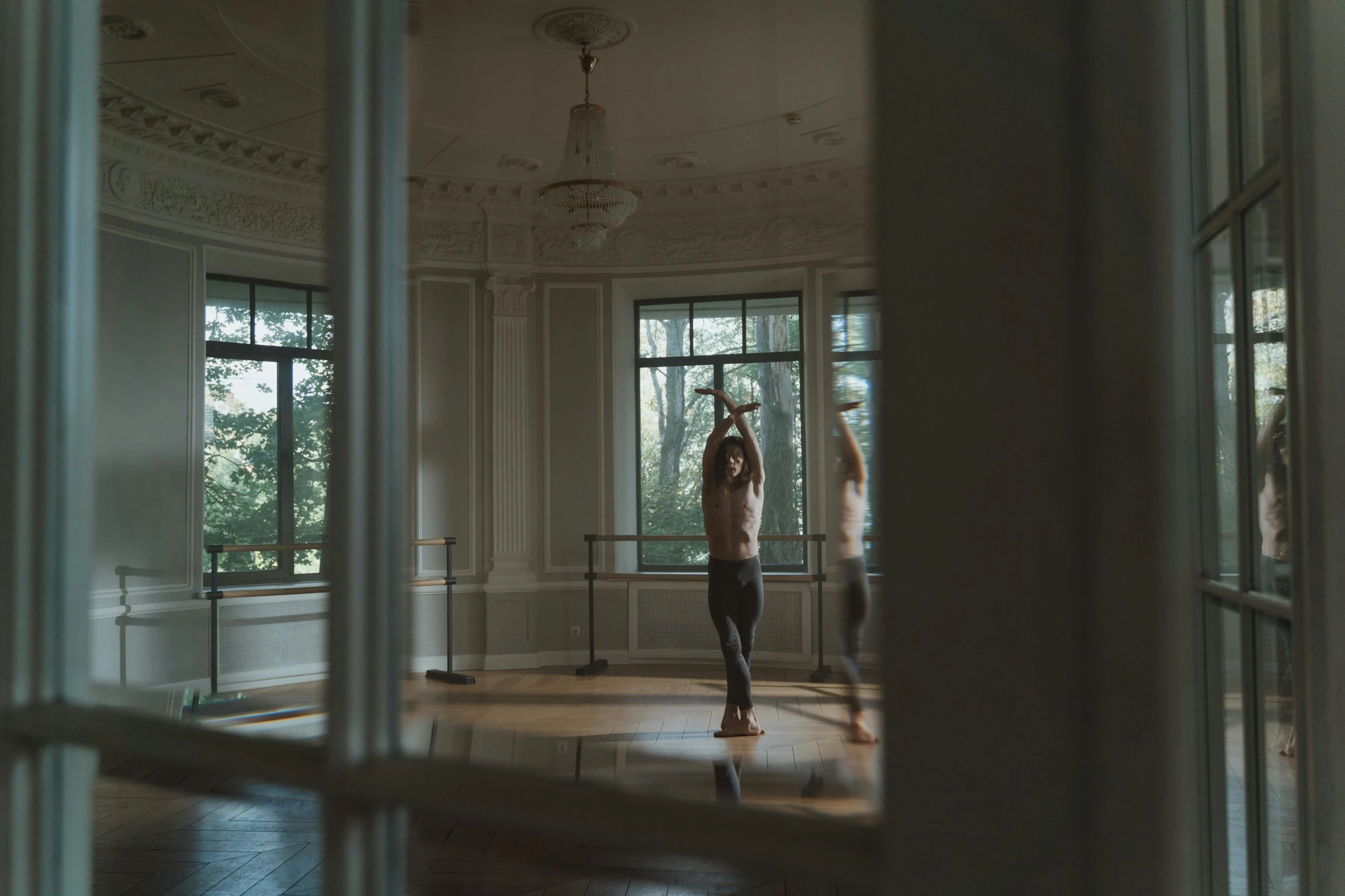 a man standing in front of two windows