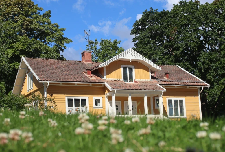 an old house sits with a yellow roof