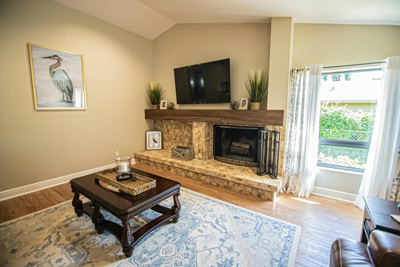 a living room area with a fireplace and large screen tv