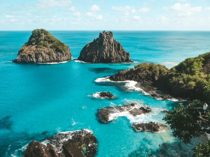 the ocean and rocks are blue in the water