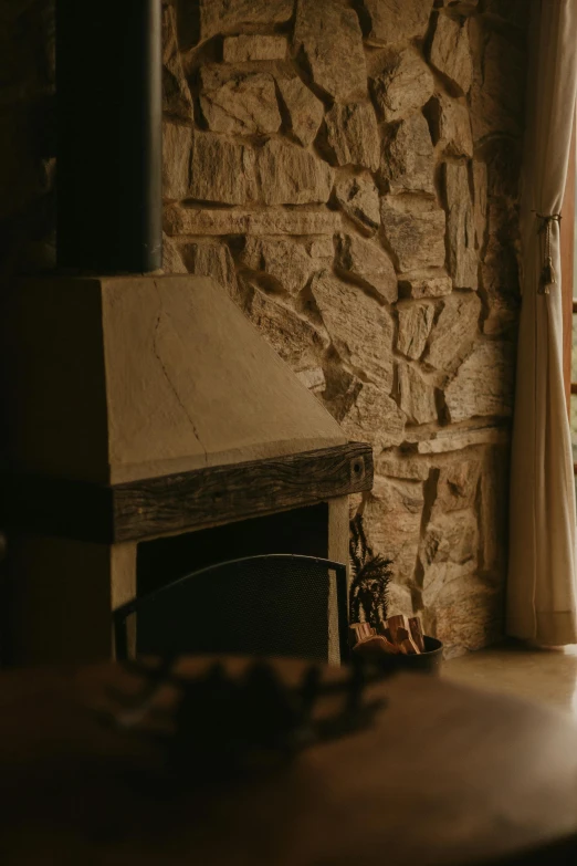 a stone fireplace in the middle of a living room