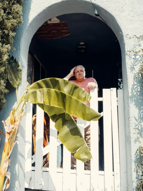 woman in red dress sitting on a blue house porch