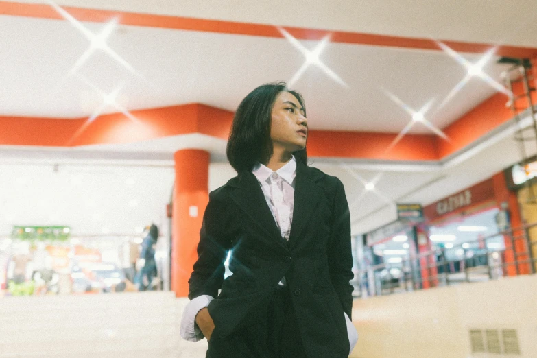 a woman standing in a hallway with her legs crossed