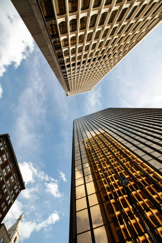 two tall buildings look very upward at the sky