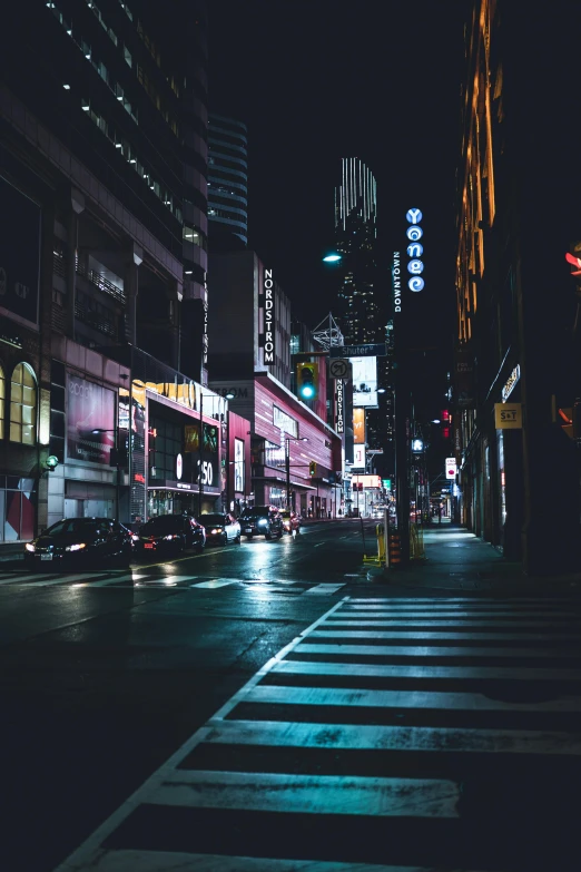 a street corner at night in tokyo with bright lights