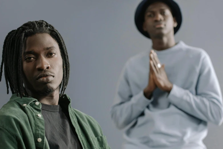 two men wearing hats and looking surprised while praying