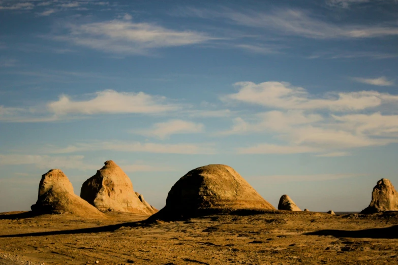 there are three big rocks that are in the desert