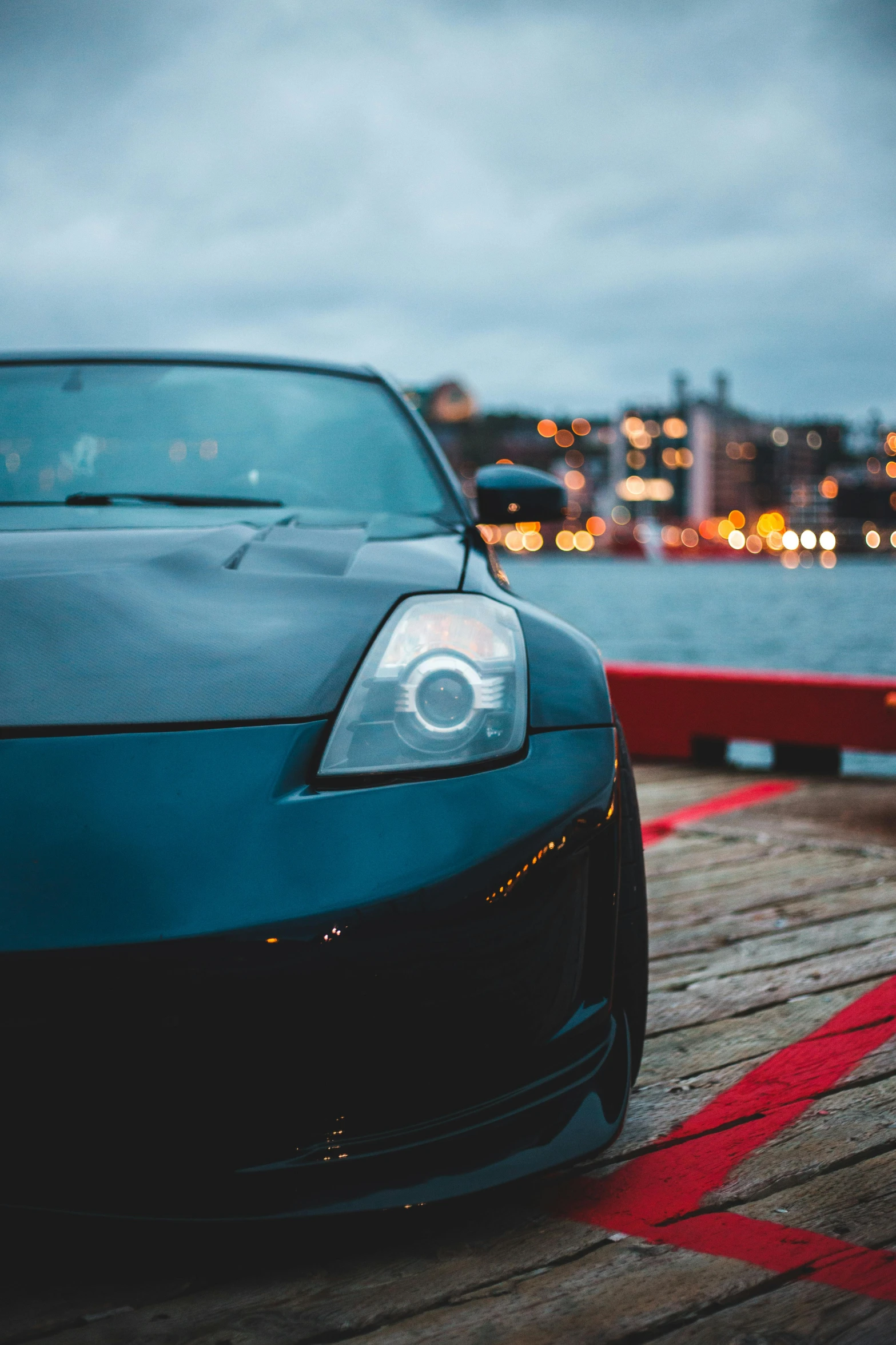 the hood of a sleek sports car on the dock