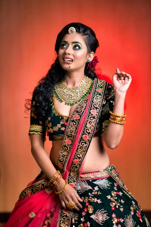 the indian girl dressed in traditional attire posing for the camera