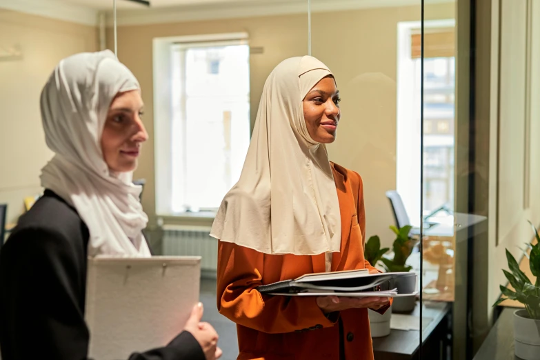 two women talking in an office setting