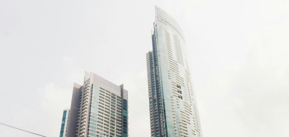 two tall buildings sitting in the middle of a city