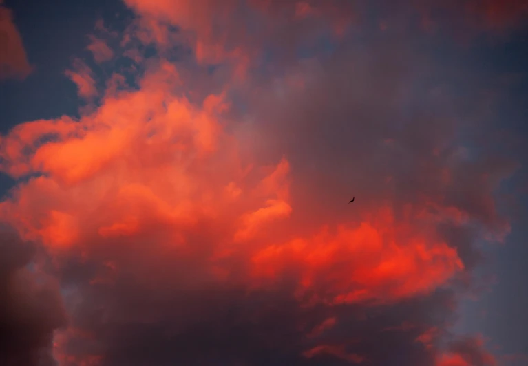 a sunset cloud is lit up with a red glow