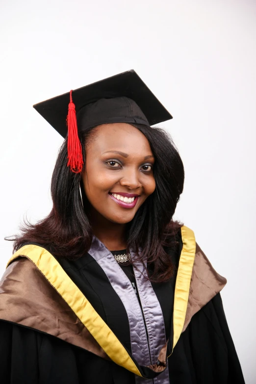a woman in a graduation gown with a graduate cap