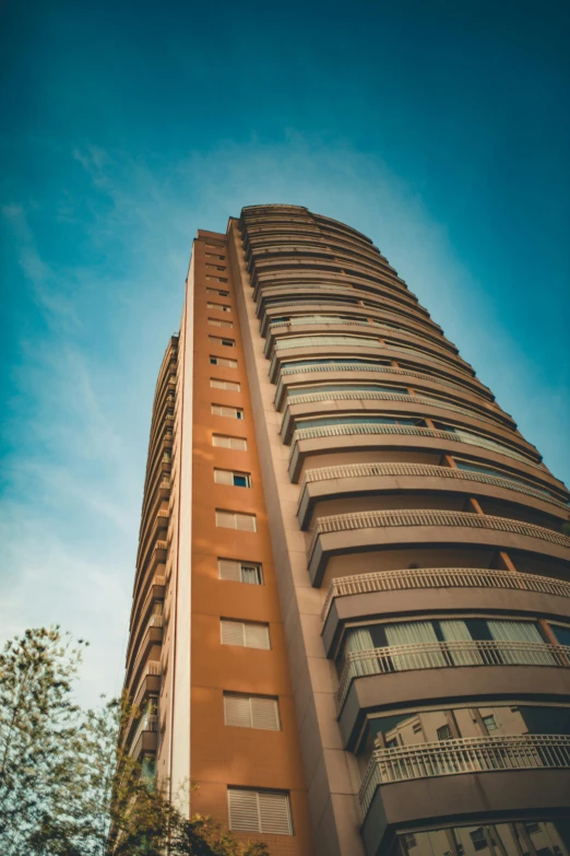 a very tall building with windows on a blue sky