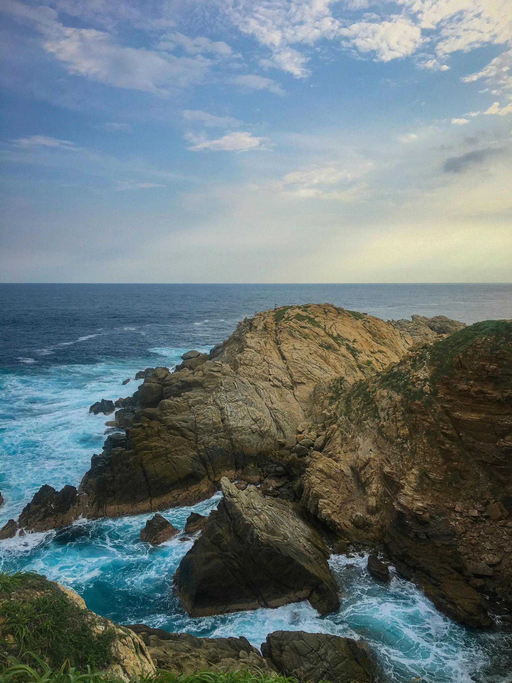 a couple of large rocks sticking out of the ocean