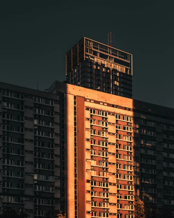 a very tall building sitting in front of some very tall buildings