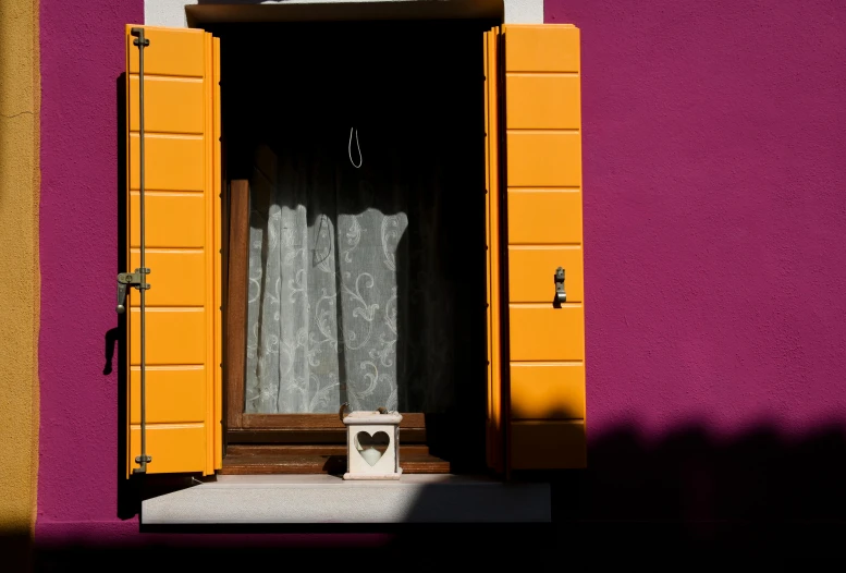 the outside of an old, yellow house with a decorative window sill