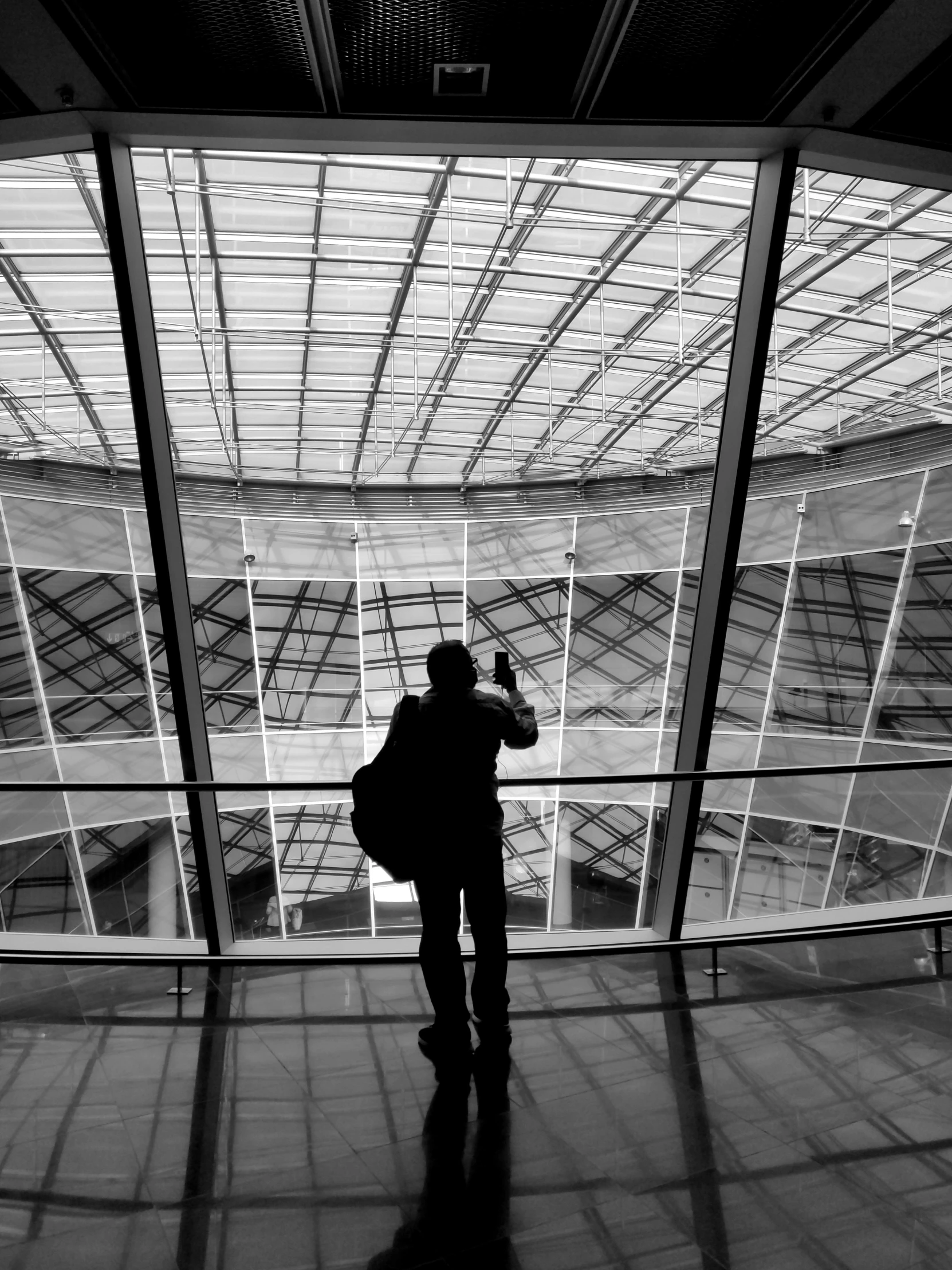 a person holding a camera near an open door