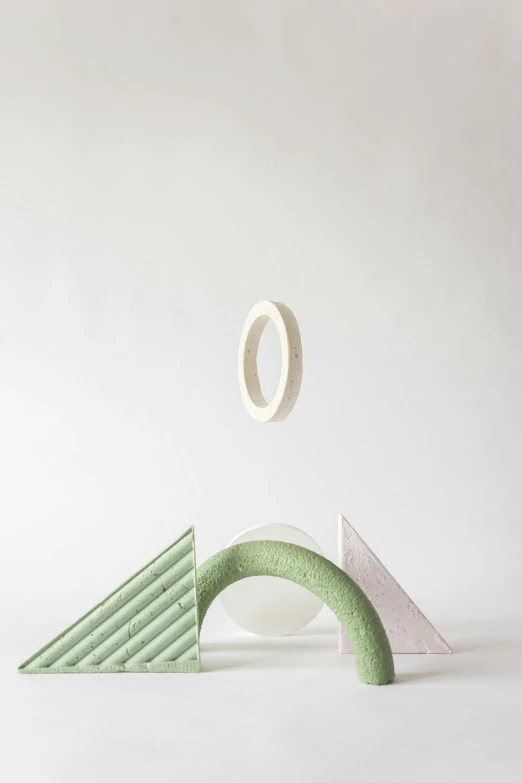 a white and green sculpture in the air