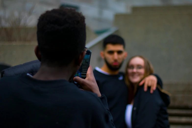 two people are looking at their phone together