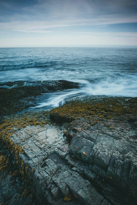 waves hitting on a beach and rocks