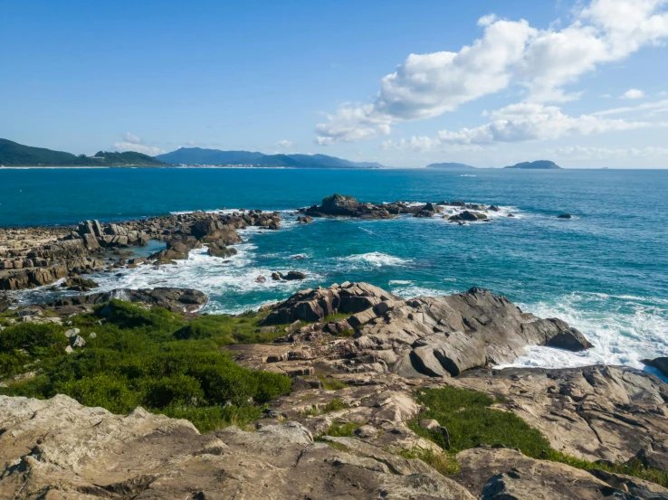 an open area with rocks and water that looks like the ocean