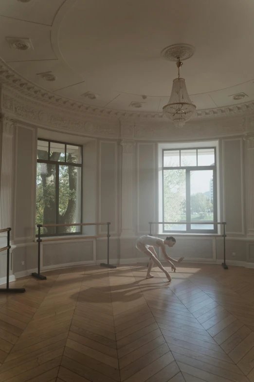 a room with large windows and some wooden flooring