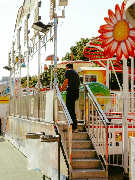 a man is going down stairs near a carnival