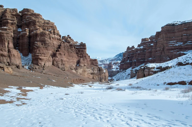 a path winds along a snowy mountain side