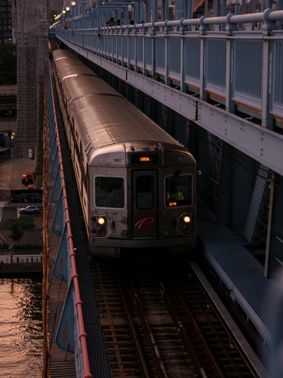 a train traveling through a city next to a bridge