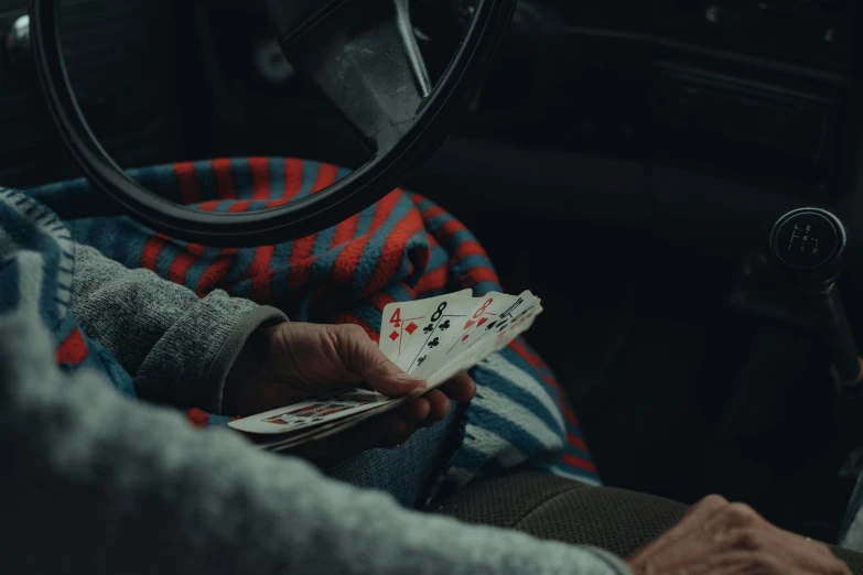 a person playing cards while in a car
