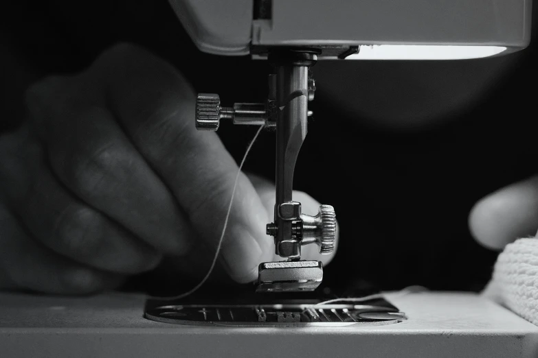 a person is stitching soing on a sewing machine