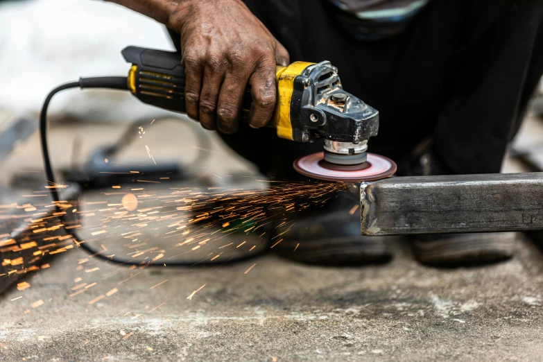 the man uses his random tool to grind holes